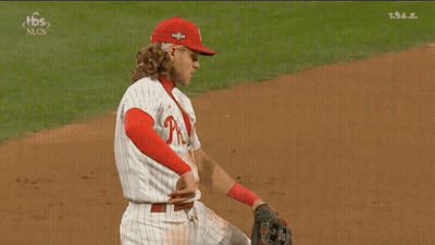 A Baseball Player Wearing A Phillies Uniform Is Kneeling On The Field GIF