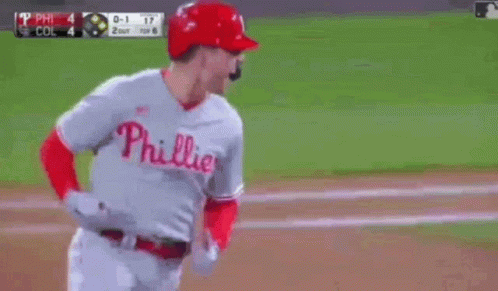 A Baseball Player Wearing A Phillies Uniform Is Running On The Field . GIF