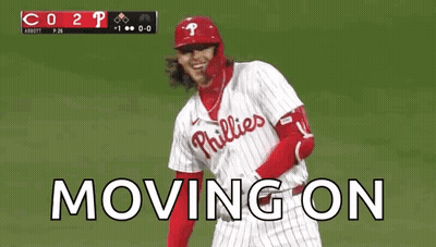 A Baseball Player Wearing A Phillies Uniform Is Standing On A Field . GIF