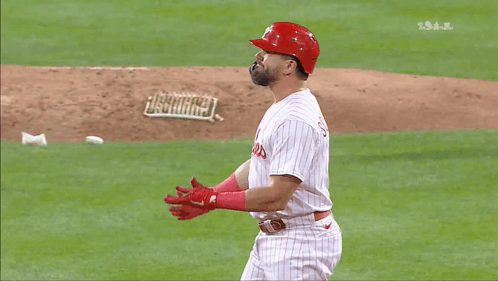 A Baseball Player Wearing A Phillies Uniform Is Standing On The Field GIF