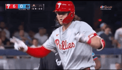 A Baseball Player Wearing A Phillies Uniform Runs Towards The Dugout GIF
