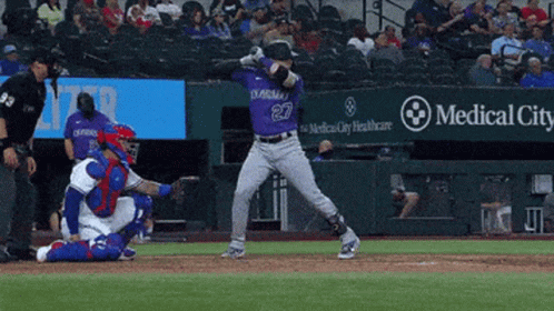 A Baseball Player Wearing A Purple Jersey With The Number 27 On It GIF