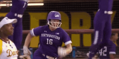 A Baseball Player Wearing A Purple Uniform With The Number 16 On It Is Running Towards The Base . GIF