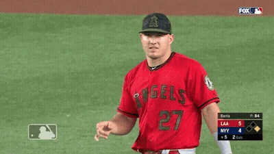 A Baseball Player Wearing A Red Angels Jersey Is Pointing GIF