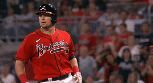 A Baseball Player Wearing A Red Braves Jersey Points At Something GIF