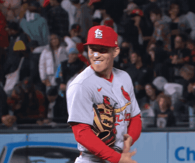 A Baseball Player Wearing A Red Cardinals Hat And Glove GIF