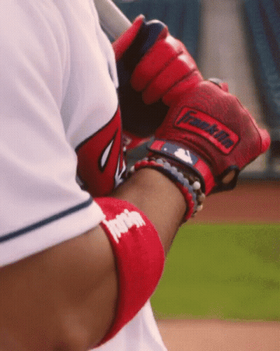 A Baseball Player Wearing A Red Franklin Glove Holds A Bat GIF