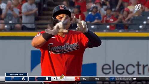 A Baseball Player Wearing A Red Guardians Jersey Makes A Peace Sign GIF