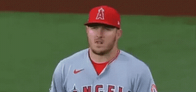 A Baseball Player Wearing A Red Hat And A Grey Jersey Is Standing On The Field . GIF