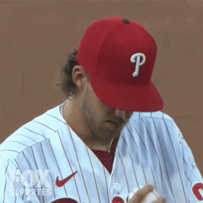 A Baseball Player Wearing A Red Hat With A Letter P On It GIF