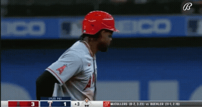 A Baseball Player Wearing A Red Helmet Stands In Front Of A Scoreboard That Says ' Lyles Pai ' On It GIF