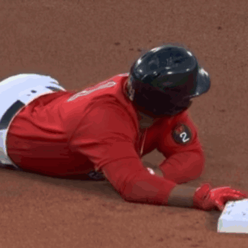 A Baseball Player Wearing A Red Jersey With The Number 2 On It Is Laying On The Ground GIF