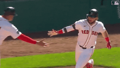 A Baseball Player Wearing A Red Sox Jersey Is Running On The Field . GIF