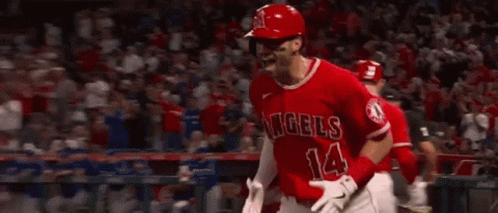 A Baseball Player Wearing A Red Uniform Is Running On The Field . GIF