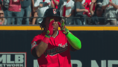 A Baseball Player Wearing A Red Uniform With The Word Guardians On The Front GIF