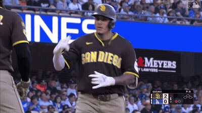 A Baseball Player Wearing A San Diego Jersey Stands In Front Of An Advertisement For Meyers GIF