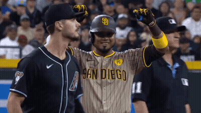 A Baseball Player Wearing A San Diego Uniform Is Standing Next To A Referee . GIF