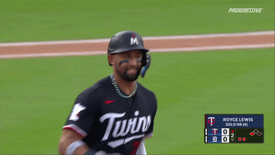 A Baseball Player Wearing A Twins Jersey Is Standing On The Field GIF