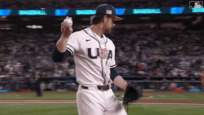 A Baseball Player Wearing A Usa Jersey Is Throwing A Baseball . GIF