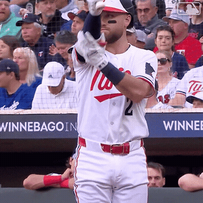 A Baseball Player Wearing A Washington Nationals Uniform Holds Up His Bat GIF