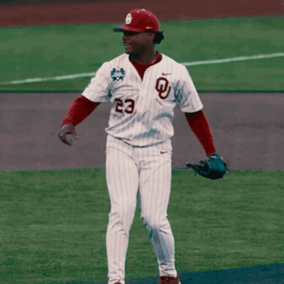 A Baseball Player Wearing A White Jersey With A Red Letter L On It GIF