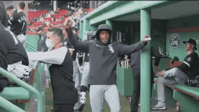 A Baseball Player Wearing A White Sox Hoodie Is Dancing In The Dugout GIF