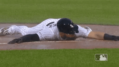 A Baseball Player Wearing A White Sox Uniform Is Laying On The Ground GIF