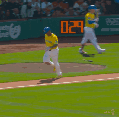 A Baseball Player Wearing A Yellow Jersey That Says Boston Is Running On The Field GIF