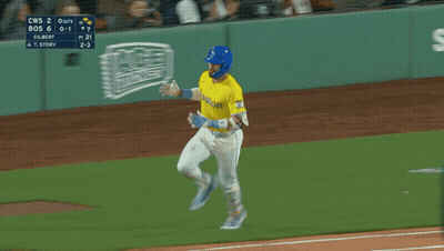 A Baseball Player Wearing A Yellow Jersey That Says Boston On It GIF