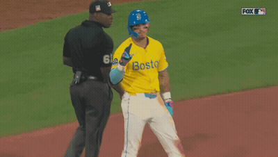 A Baseball Player Wearing A Yellow Jersey With Boston On It GIF