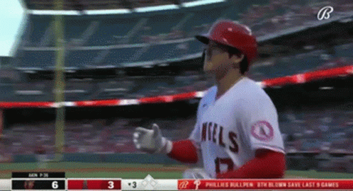 A Baseball Player Wearing An Angels Jersey Is Standing On The Field GIF