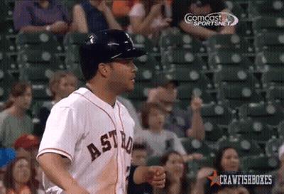 A Baseball Player Wearing An Astros Jersey Is Standing In Front Of A Crowd GIF