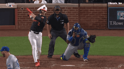 A Baseball Player Wearing An Orioles Jersey Is Talking To A Referee GIF