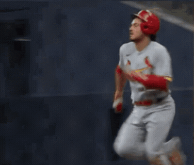 A Baseball Player Wearing Number 28 Is Running Towards Home Plate GIF
