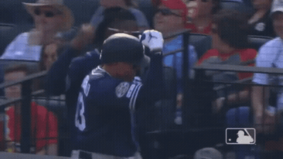 A Baseball Player Wearing Sunglasses And A Jersey With The Number 7 On It Is Talking To Another Player . GIF
