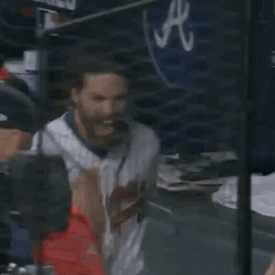 A Baseball Player With A Beard Is Sitting In The Dugout At A Game . GIF