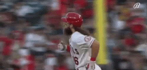 A Baseball Player With A Long Beard Is Running Towards Home Plate During A Game . GIF