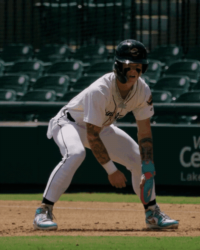 A Baseball Player With A Tattoo On His Arm Stands On The Base GIF