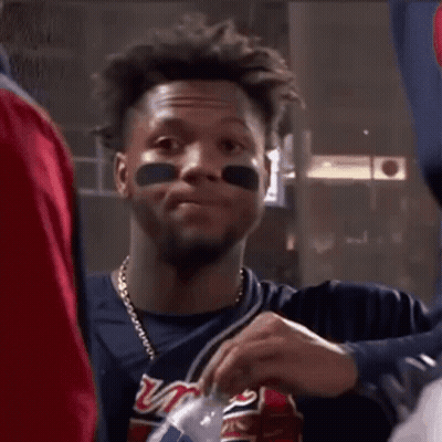 A Baseball Player With A Washington Nationals Jersey On Is Holding A Can Of Soda . GIF