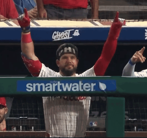 A Baseball Player With His Arms In The Air Behind A Smartwater Advertisement GIF