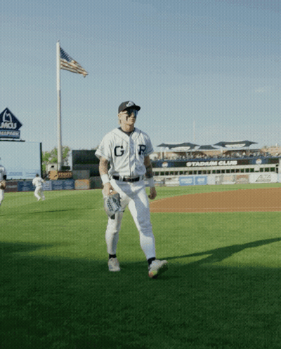 A Baseball Player With The Letter G On His Jersey Stands On A Field GIF
