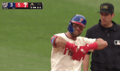 A Baseball Player With The Letter P On His Helmet Stands Next To A Referee GIF