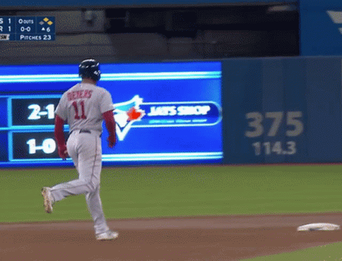 A Baseball Player With The Number 11 On His Jersey Is Running GIF