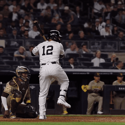 A Baseball Player With The Number 12 On His Back Is About To Swing His Bat GIF