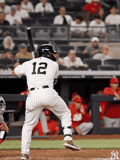 A Baseball Player With The Number 12 On His Jersey Getting Ready To Bat GIF