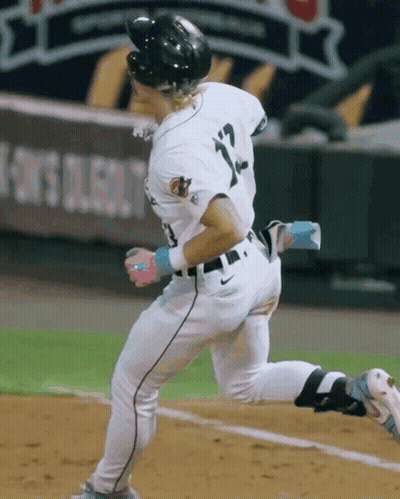 A Baseball Player With The Number 12 On His Jersey Is Running GIF