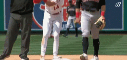 A Baseball Player With The Number 14 On His Jersey Is Standing On The Base . GIF