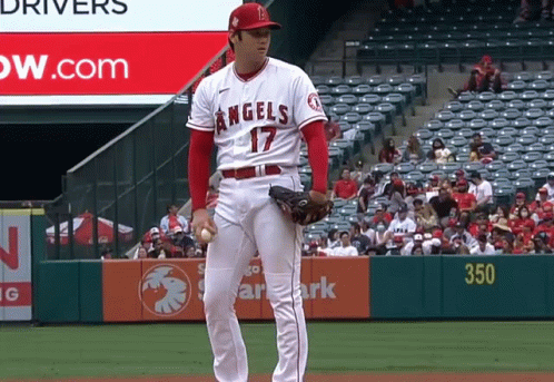 A Baseball Player With The Number 17 On His Jersey Stands On The Field GIF