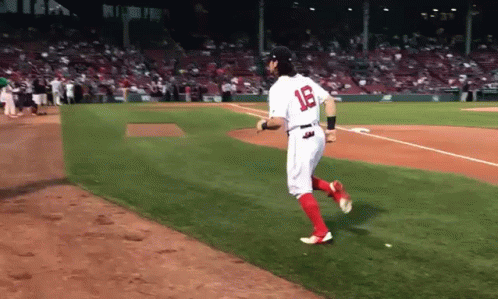 A Baseball Player With The Number 18 On His Jersey Is Running On The Field GIF