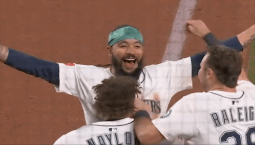 A Baseball Player With The Number 20 On His Back Is Hugging Another Player GIF